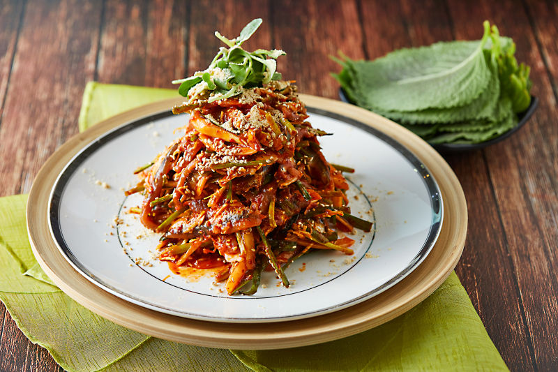 Sliced raw anchovy dish with shredded vegetables in a spicy sauce