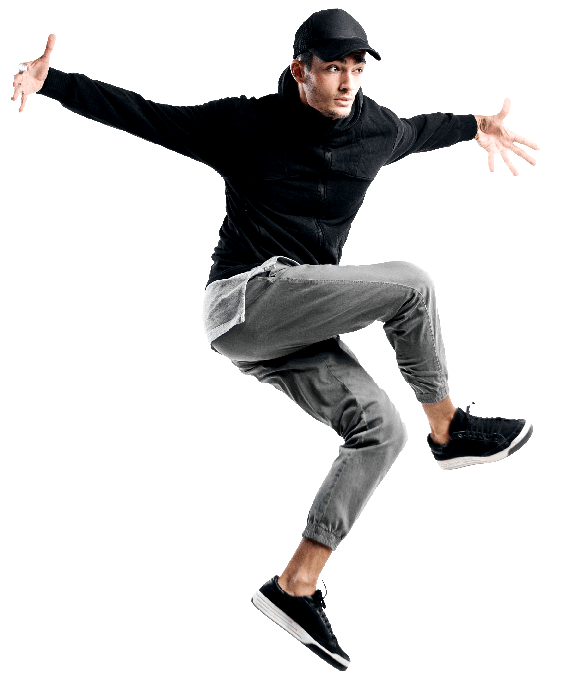 Handsome young dancer wearing a black sweatshirt, gray pants and a cap is dancing breakdance