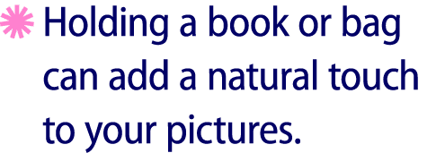 ￼ Holding a book or bag can add a natural touch to your pictures.