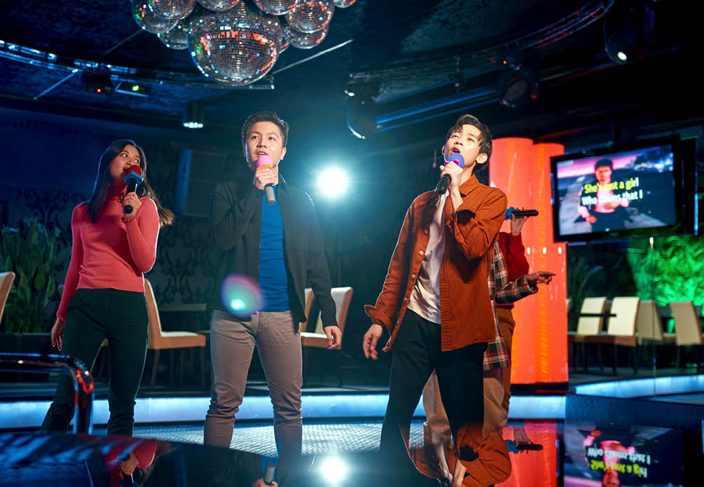 Singing songs karaoke and dancing on night club stage, njoying friendship together in bar, Concept of party, holiday, relaxation, Spend day-off in karaoke together with friends, enjoy time in club